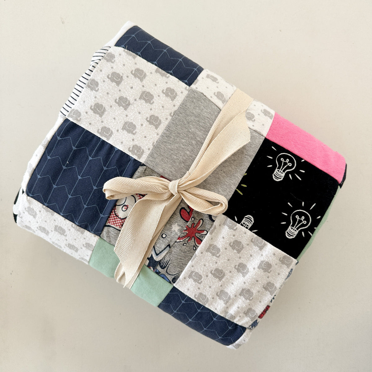 Keepsake quilt sewn from baby clothes