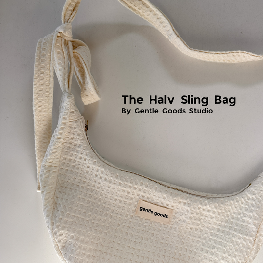 Beige sling bag with 'Gentle Goods Studio' label on a gray background