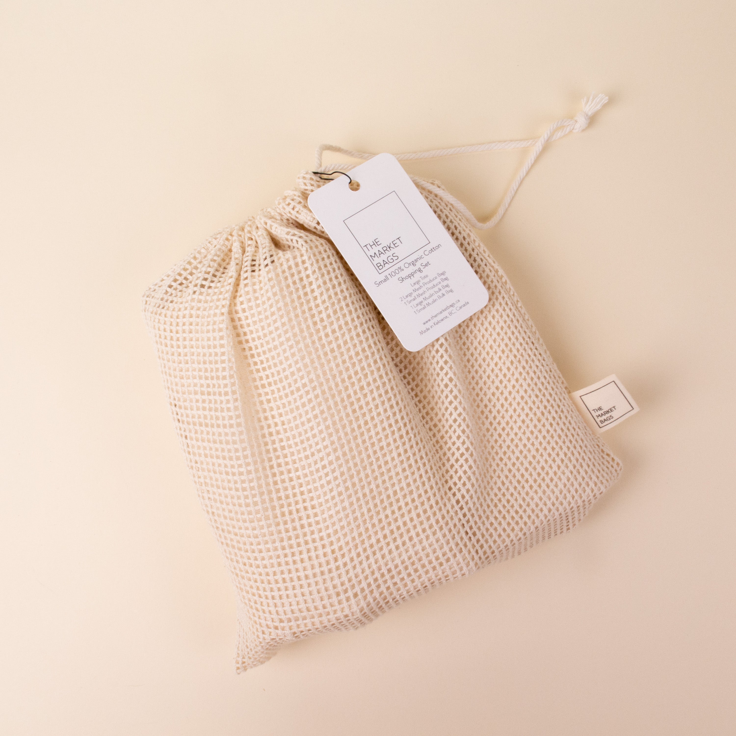 Canvas bag with drawstring, mockup of small eco sack made from natural cotton  fabric cloth flat lay on green pastel background from top view Stock Photo  | Adobe Stock